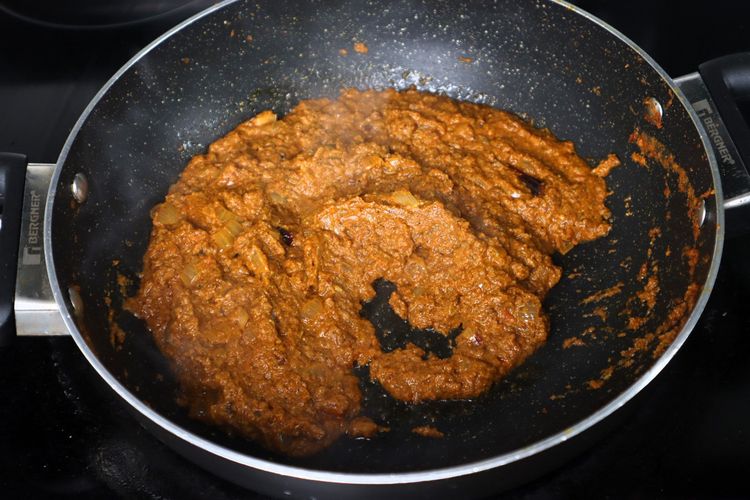 Step 2.4: Add tomato puree and sauté until oil separates
