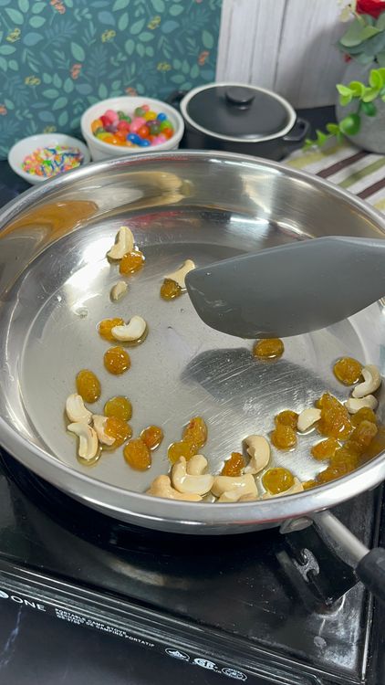 Step 1.1: Fry on low heat until cashews turn golden and raisins puff up