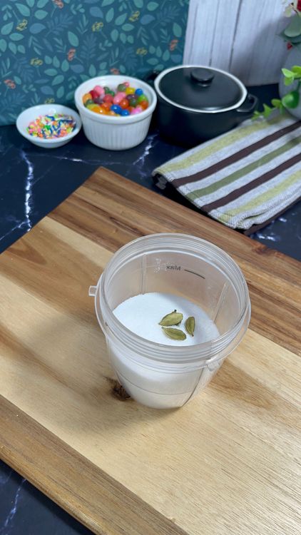 Step 3.1: Add sugar and cardamom seeds to a blender