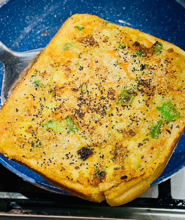 Step 1.1: Use a flat spatula to carefully flip the bread slices and cook for a few more minutes until they become golden brown and crispy below