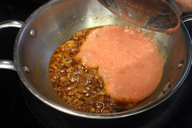 Step 2.2: Add the tomato puree and cook until the oil starts separating from the mixture