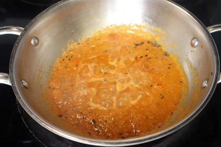 Step 2.3: Add the tomato puree and cook until the oil starts separating from the mixture