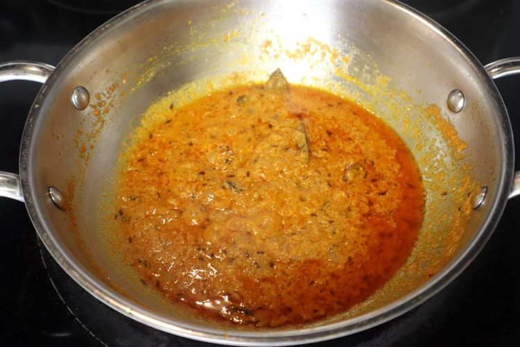 Step 2.3: Lower the flame, add curd, and cook until the oil separates again
