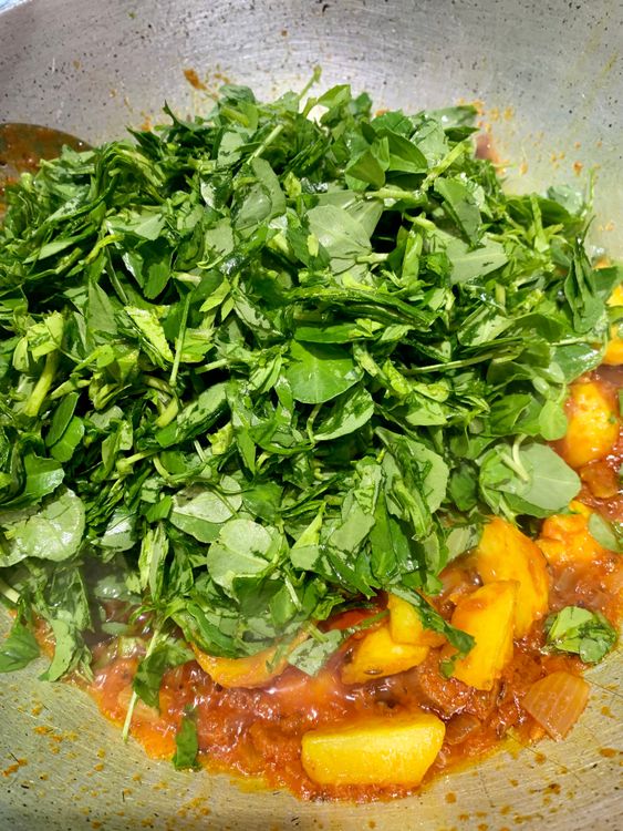 Step 1.1: Now, add the chopped fenugreek leaves to the wok
