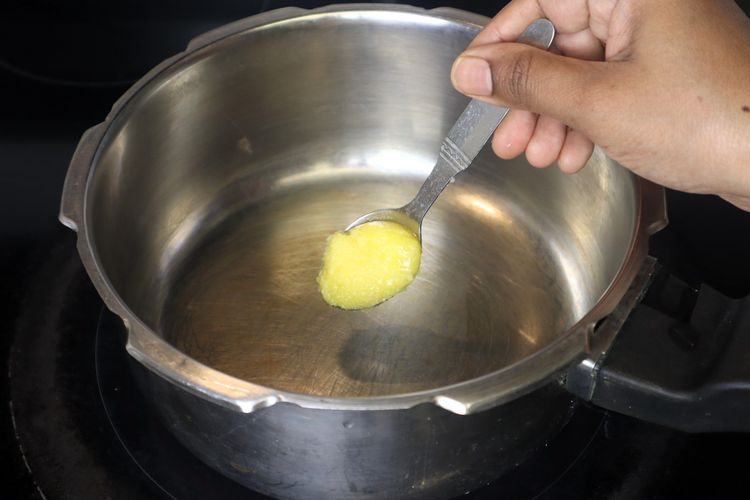 Step 2.1: In a pressure cooker, heat 2 tsp of ghee over medium heat until it shimmers