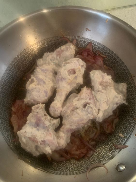 Step 4.1: Add the marinated chicken pieces to the pan, reserving any excess marinade for later