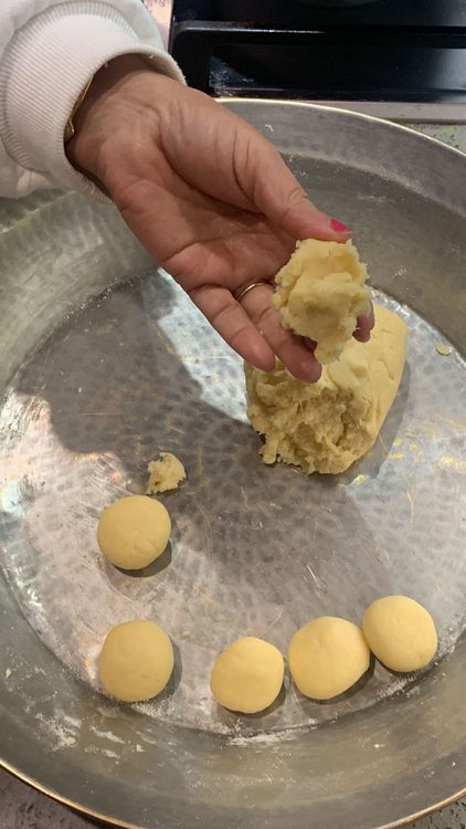 Step 2.1: Take small portions of the dough and shape them into small lemon-sized balls, ensuring there are no cracks