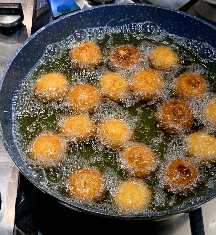 Step 2.1: Add the dough balls to the hot oil and fry them on medium heat until golden-dark brown