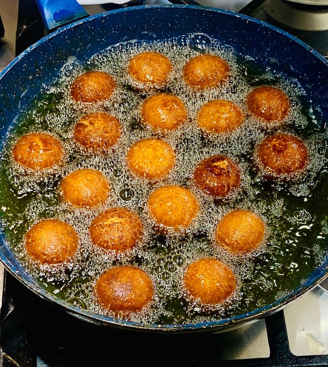Step 2.2: Add the dough balls to the hot oil and fry them on medium heat until golden-dark brown