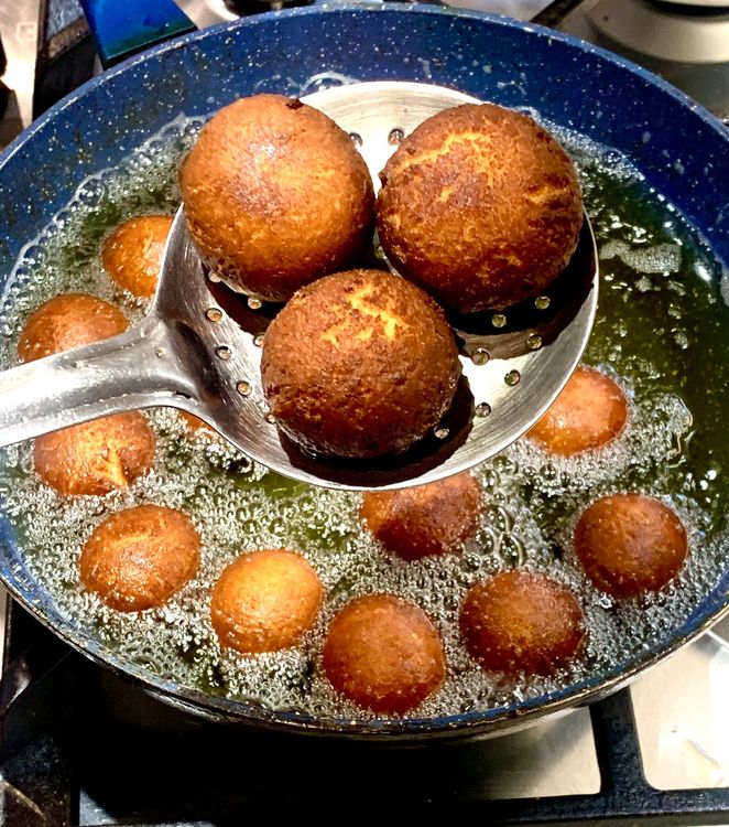 Step 2.1: Use a slotted spoon to remove the fried balls from the oil and place them on a kitchen towel to absorb excess oil