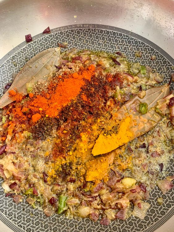Step 2.1: Add the green chillies, stir and add coriander powder, roasted cumin powder, turmeric powder, and Kashmiri red chilli powder