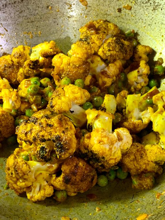 Step 2.1: Add the cauliflower florets, sprinkle water and gently mix