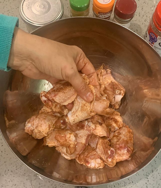 Step 1.2: In a mixing bowl, coat the chicken wings with salt, white pepper powder, cayenne powder, 5 Spice powder, mixed herbs and chopped basil leaves