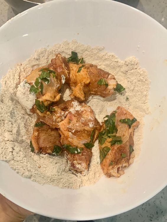 Step 1.2: Take each marinated chicken wing and coat it thoroughly with the flour mixture