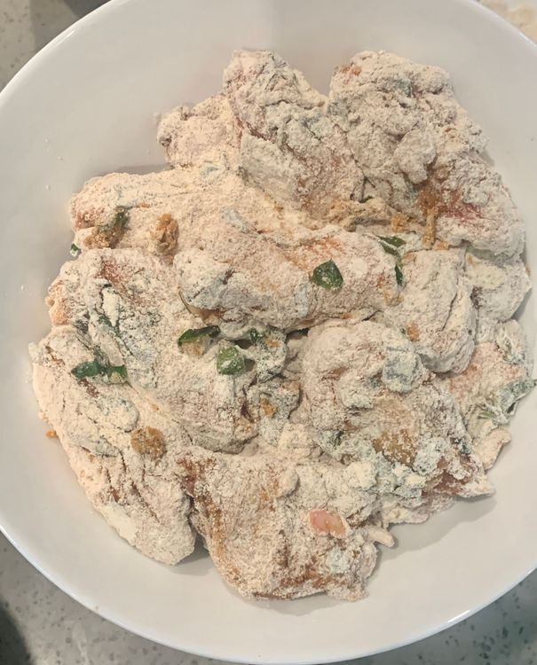 Step 1.3: Take each marinated chicken wing and coat it thoroughly with the flour mixture