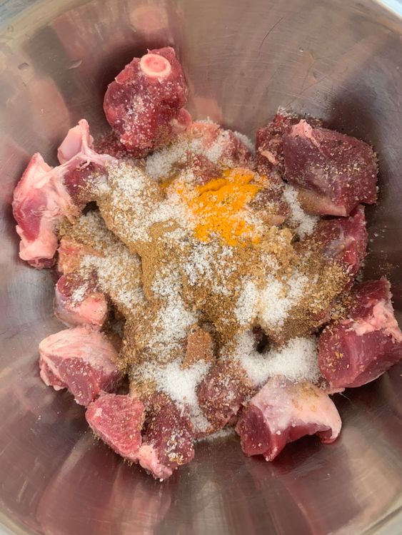 Step 1.1: In a large mixing bowl, combine the mutton with ginger-garlic paste, cumin powder, coriander powder, turmeric powder, black pepper, [garam masala powder](https://www