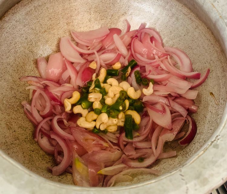 Step 2.1: Stir in 10 slit green chillies, cashews, and blanched almonds