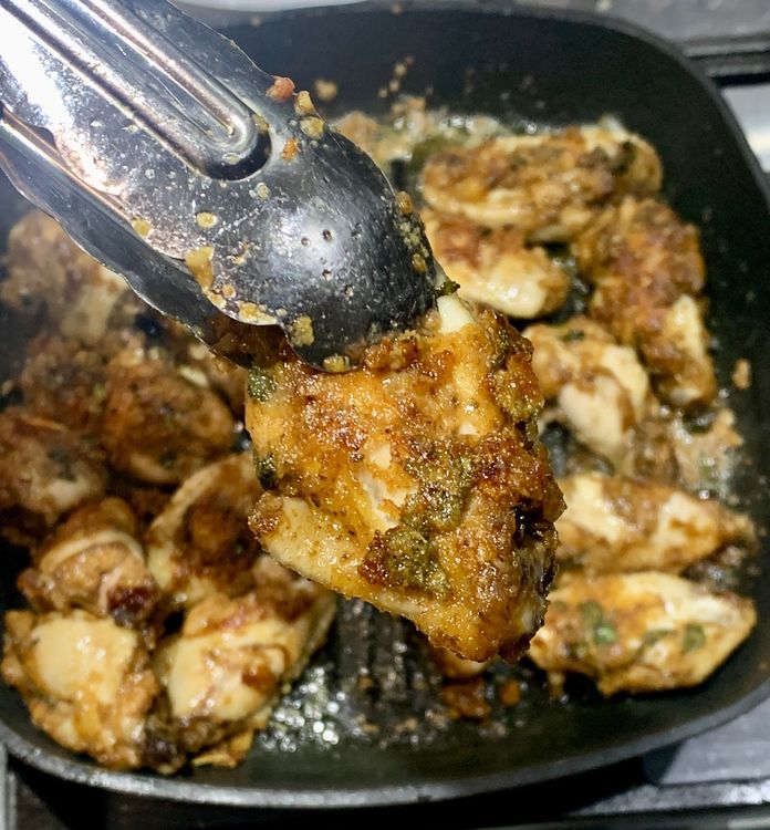 Step 1.3: Place the coated chicken wings on the heated grill pan