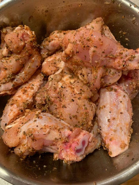 Step 1.1: Add 1 tablespoon of olive oil, oregano, rosemary (finely chop the leaves, discarding the stem), minced garlic, salt, and freshly ground black pepper to the bowl with the wings