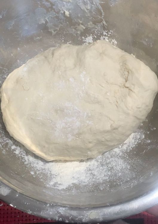 Step 1.3: Make a well in the centre of the flour mixture and pour in the yeast mixture and olive oil (5 tbsp)