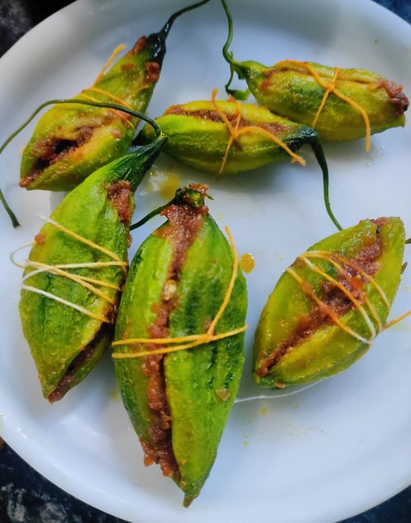 Step 2.1: After all the karela's are filled tie them with the help of a thread so that at the time of shallow frying them the stuffing does not comes out