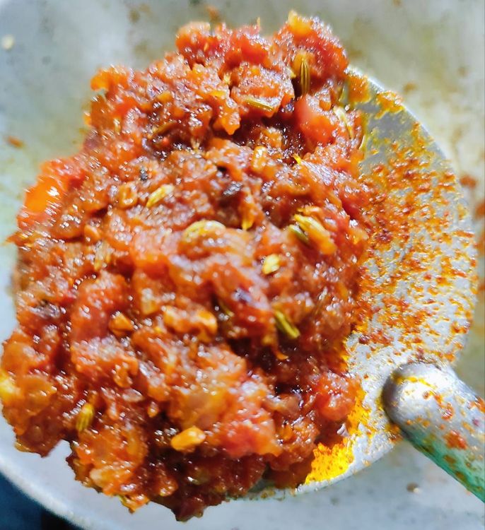 Step 2.1: Now in the same pan add Onion and sorte till they turn translucent, now at this stage add tomato to the onion mixture ,add red chilli powder ,turmeric powder, coriander powder ,garam masala powder, salt,amchur powder mix the spices and keep stirring at intervals cook for 3-4 minutes till the oil starts to ooze out 
