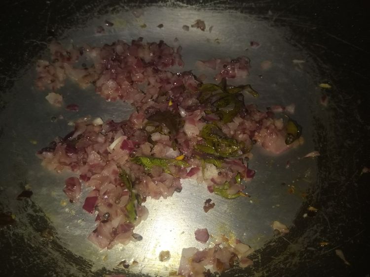 Step 1.1: Add a tablespoon of oil to the pan, put in the mustard seeds, curry leaves, chopped chillies and onions