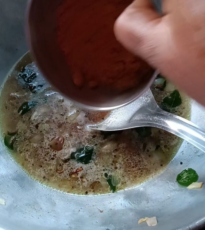 Step 1.1: Add soaked tamarind along with the water, coconut grates, sambar powder, salt, and jaggery