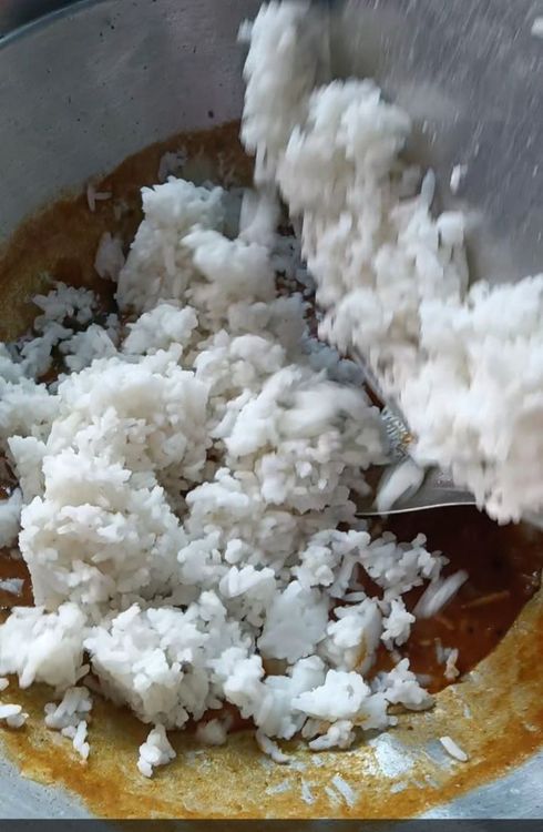 Step 1.1: Add the cooked rice to the mixture and mix well until the rice is evenly coated with the tamarind mixture
