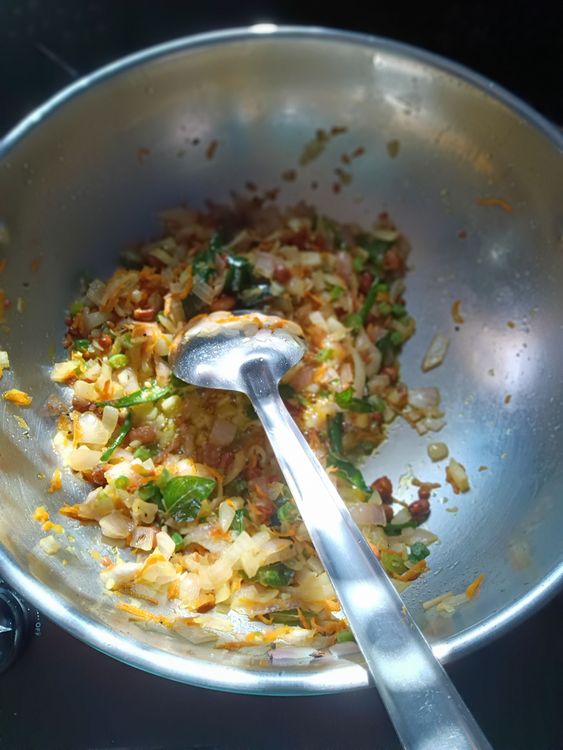 Step 1.1: Add chopped onions, green chilies, and curry leaves