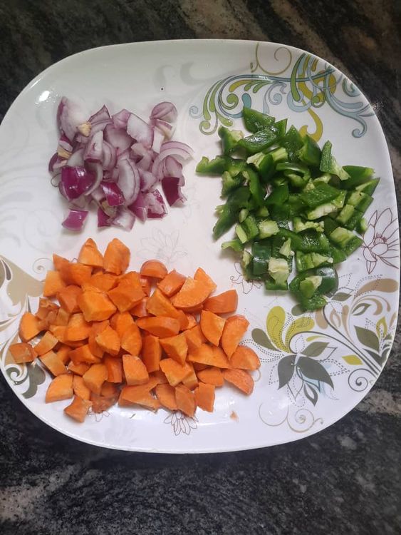 Step 2.1: Add the diced green bell pepper, remaining onion, and carrot to the pot