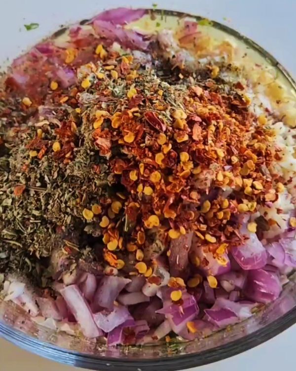 Step 1.1: In a large mixing bowl, combine the chopped garlic, red onion, coriander, red wine vinegar, olive oil, dried mixed herbs, salt, pepper, and chili flakes