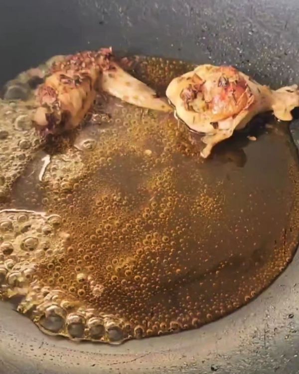 Step 2.1: Add the browned chicken wings to the pan, and toss them in the honey to coat each wing evenly