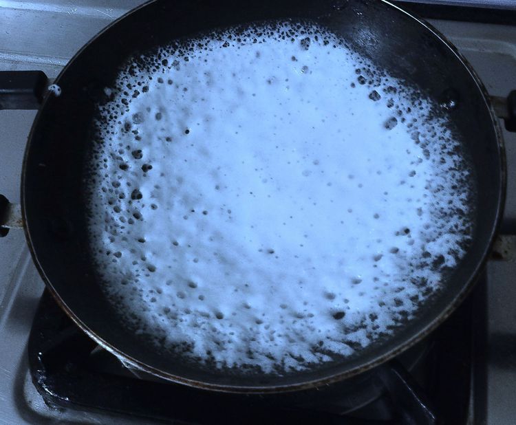Step 1.2: Pour one ladle of batter into the pan and tilt it in a circular motion to spread the batter into a round shape
