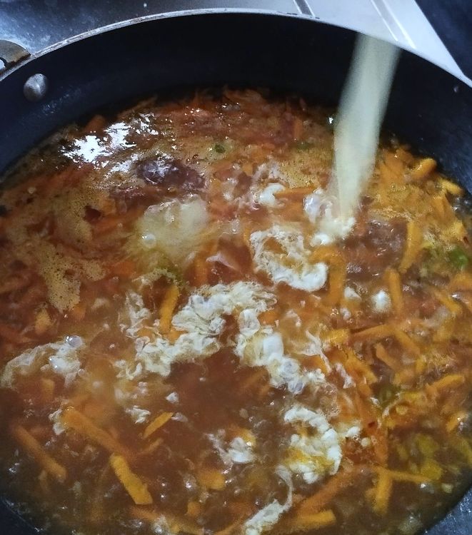 Step 1.1: When the stock water starts to boil vigorously, slowly drizzle the beaten egg in a circular motion into the stock water