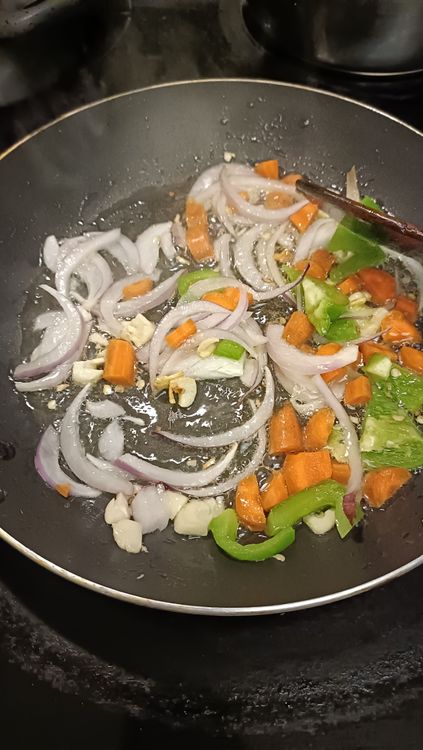 Step 2.1: Add cubed onions, chopped carrots, capsicum, and sweet corn