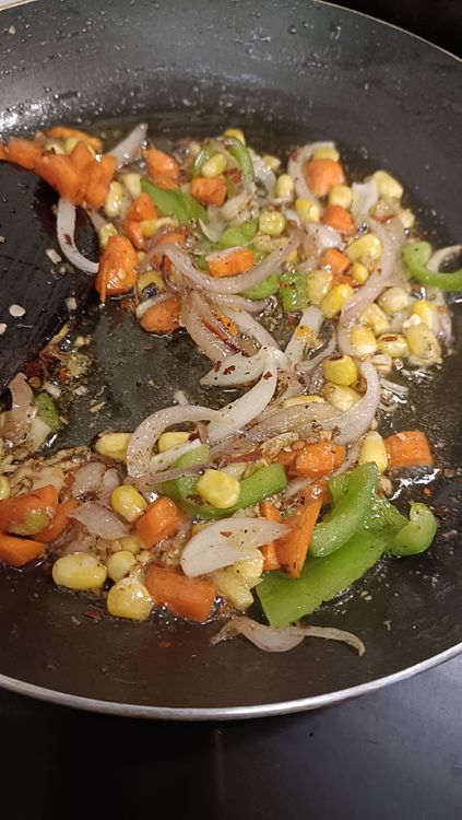 Step 2.2: Add cubed onions, chopped carrots, capsicum, and sweet corn