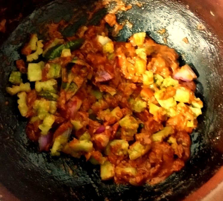 Step 2.1: Add the fried bitter gourd pieces and shallots pieces