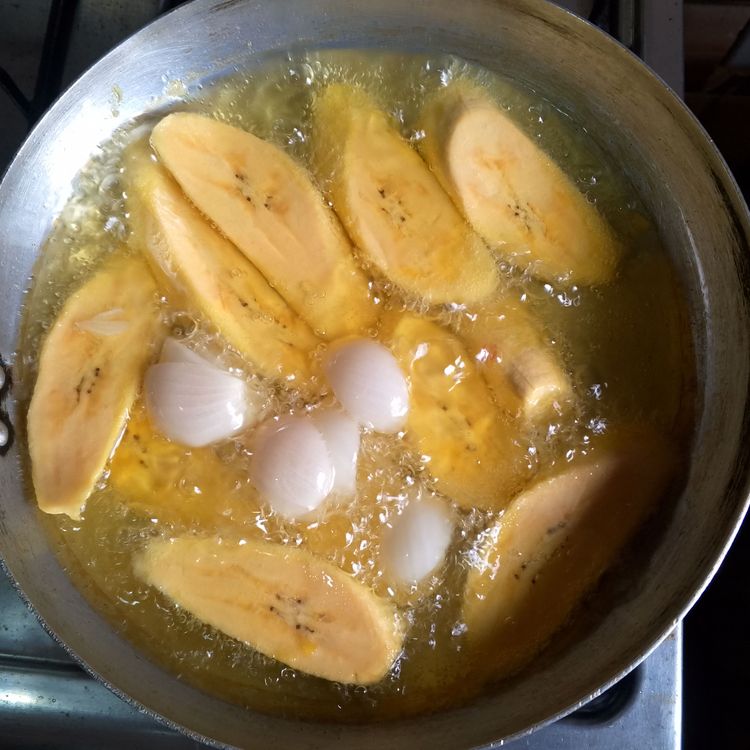 Step 1.1: Heat up the groundnut oil in a pan then add 1 onion bulb before adding the plantains