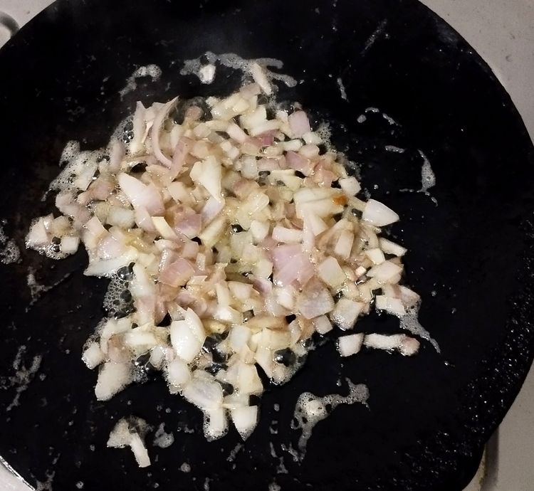 Step 1.1: To the same tawa with butter, add chopped onion and salt