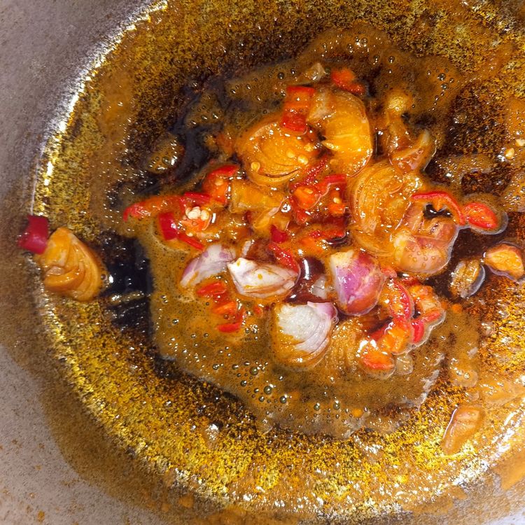 Step 1.1: Heat the palm oil in a pot and sauté the chopped onion until translucent