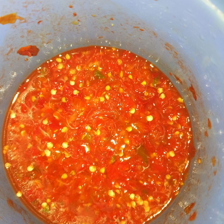 Step 1.1: Blend the fresh tomatoes, bell peppers, scotch bonnet peppers, and garlic into a smooth paste