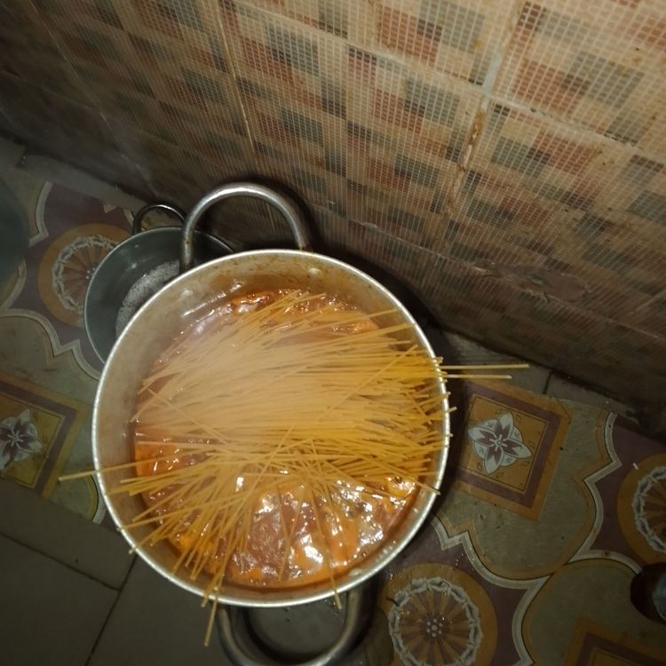 Step 1.1: Break the spaghetti into smaller pieces if desired, and add it to the pot
