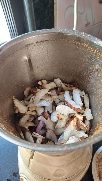 Step 5.1: Add the dry roasted onion, garlic, and coconut along with rock salt to the mixie jar