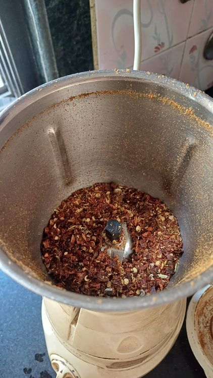Step 5.1: Transfer the dry roasted spices and roasted chilies into a mixie jar and grind into a fine powder