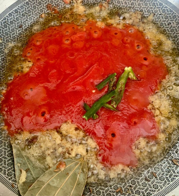 Step 2.1: Stir in the tomato puree and slit green chillies