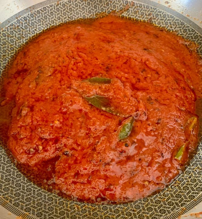 Step 2.2: Stir in the tomato puree and slit green chillies