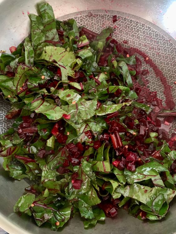 Step 1.1: Toss in the chopped beet greens, using tongs to mix them until wilted and tender