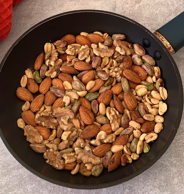 Step 1.1: In a dry skillet over medium heat, toast the mixed nuts and peanuts until they become lightly golden and aromatic