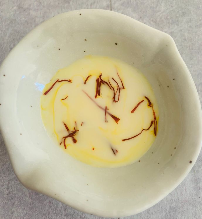 Step 1.1: Warm a tablespoon of milk slightly and add the saffron strands